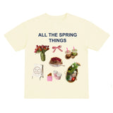 Beige t-shirt with spring-themed graphics and text on a white background