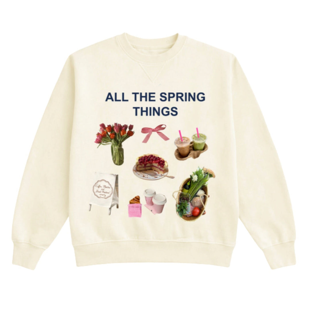 Cream-colored sweatshirt with spring-themed graphics and text on a white background