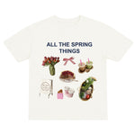 White t-shirt with spring-themed graphics and text on a white background