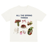 White t-shirt with spring-themed graphics and text on a white background