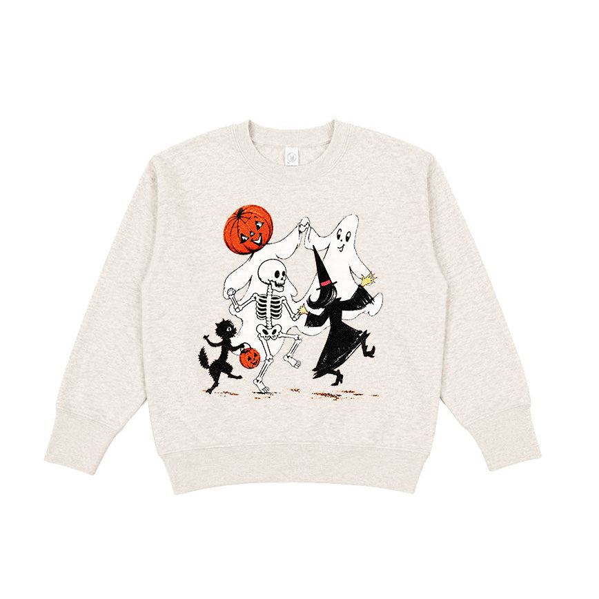 An off-white crewneck sweatshirt featuring a graphic print of a skeleton, a ghost, a black cat, and a jack-o'-lantern pumpkin dancing together.
