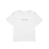 White t-shirt with green text on a white background