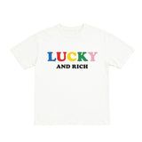 White t-shirt with 'LUCKY AND RICH' text in colorful letters on a white background