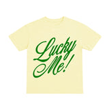 Yellow t-shirt with green 'Lucky Me!' text on a white background