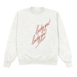 White sweatshirt with red text 'lucky you!' on a white background