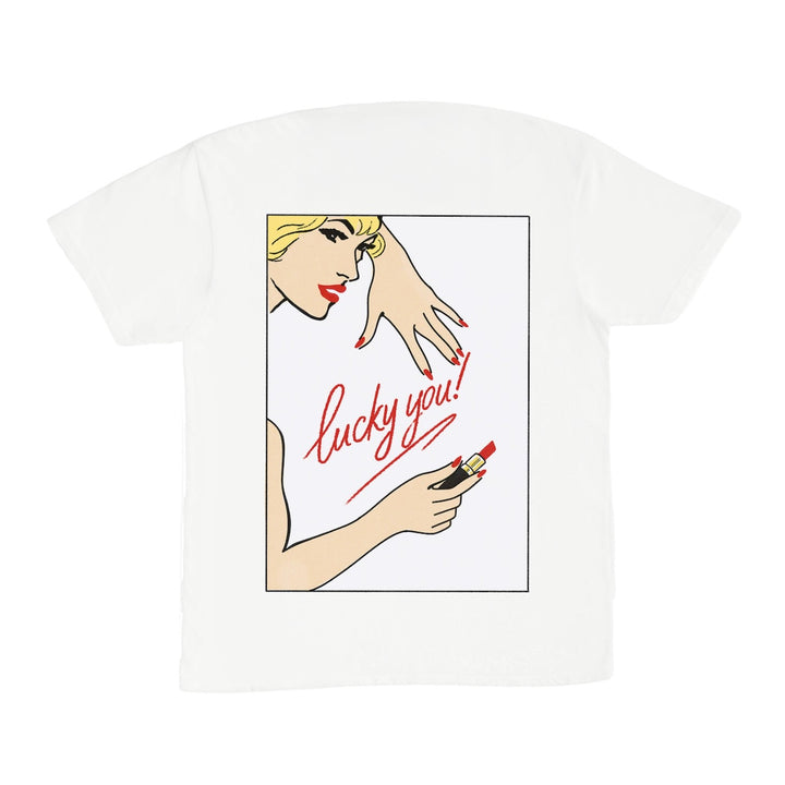 White t-shirt with graphic design of a woman applying lipstick and text &