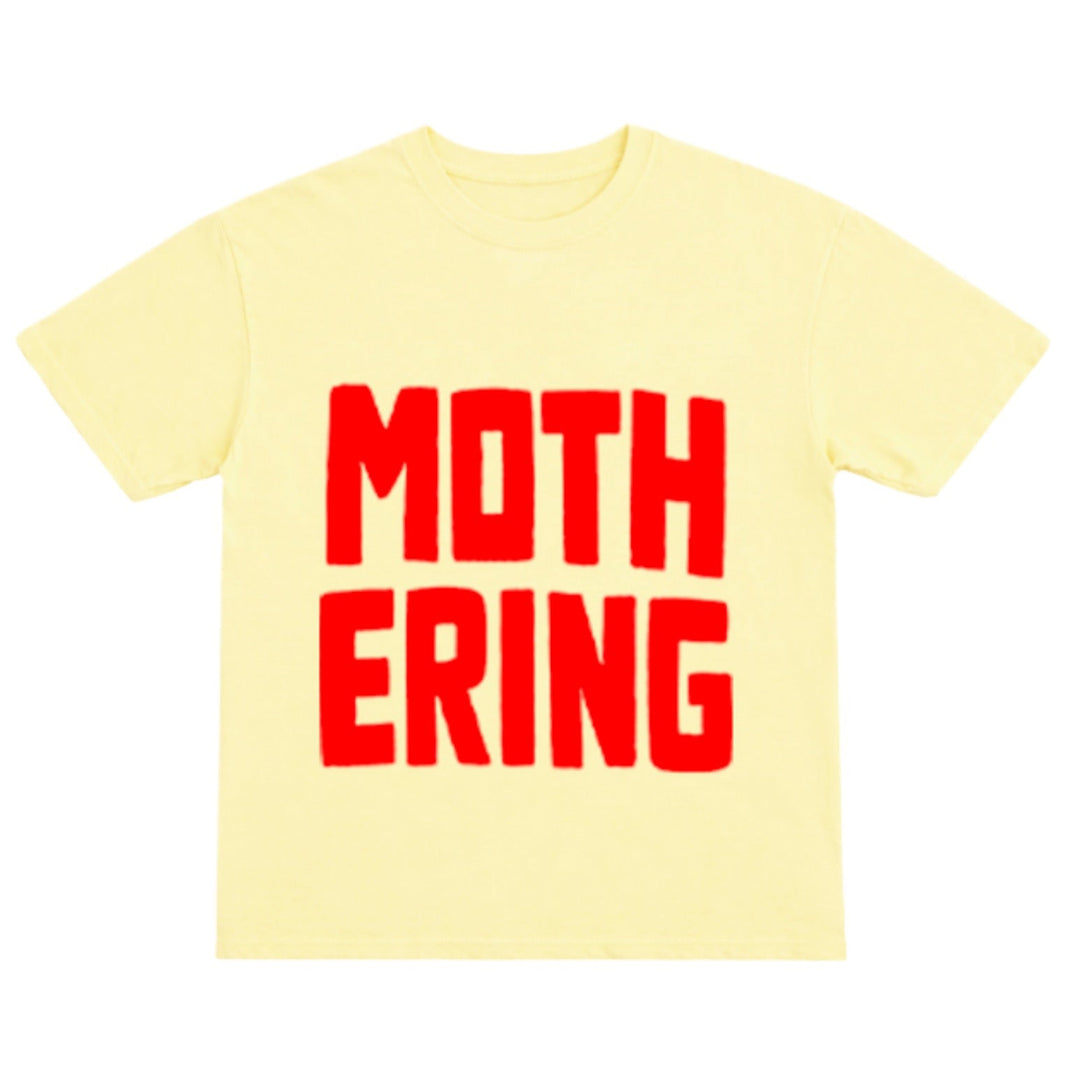 Yellow t-shirt with red text 'MOTHERING' on a white background