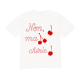 White t-shirt with red text 'Non, ma chérie' and cherries on a white background