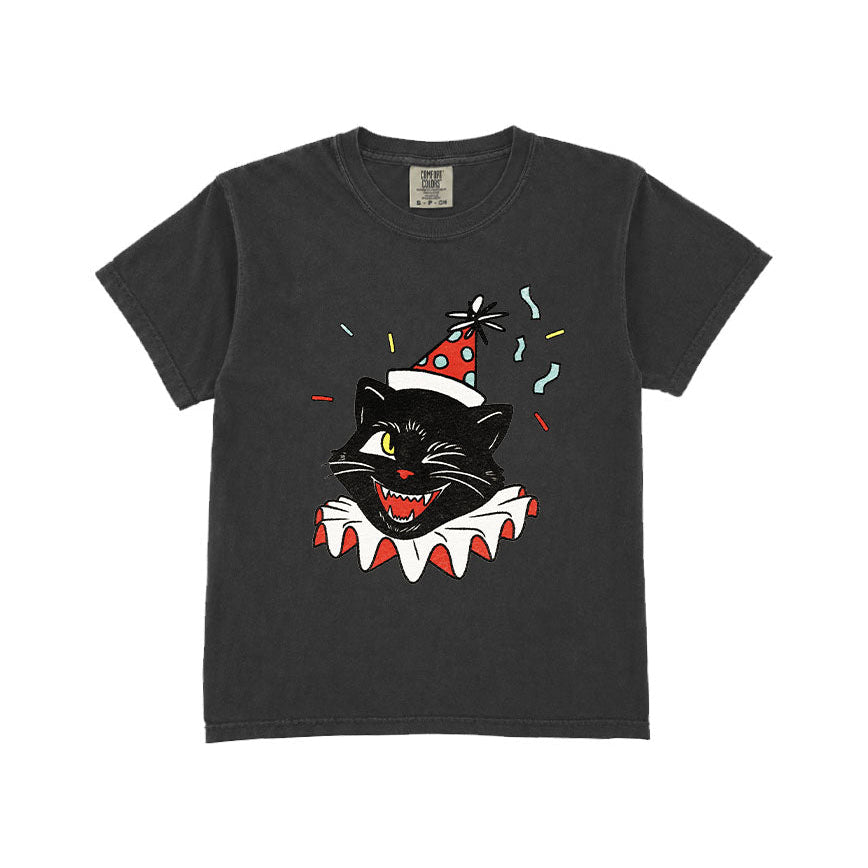 A dark gray short-sleeve t-shirt with a graphic of a black cat wearing a red party hat and a white ruffled collar, surrounded by colorful confetti, on a solid white background.