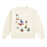 Cream-colored sweatshirt with sailboat designs on a white background