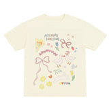Beige t-shirt with colorful graphics and text on a white background