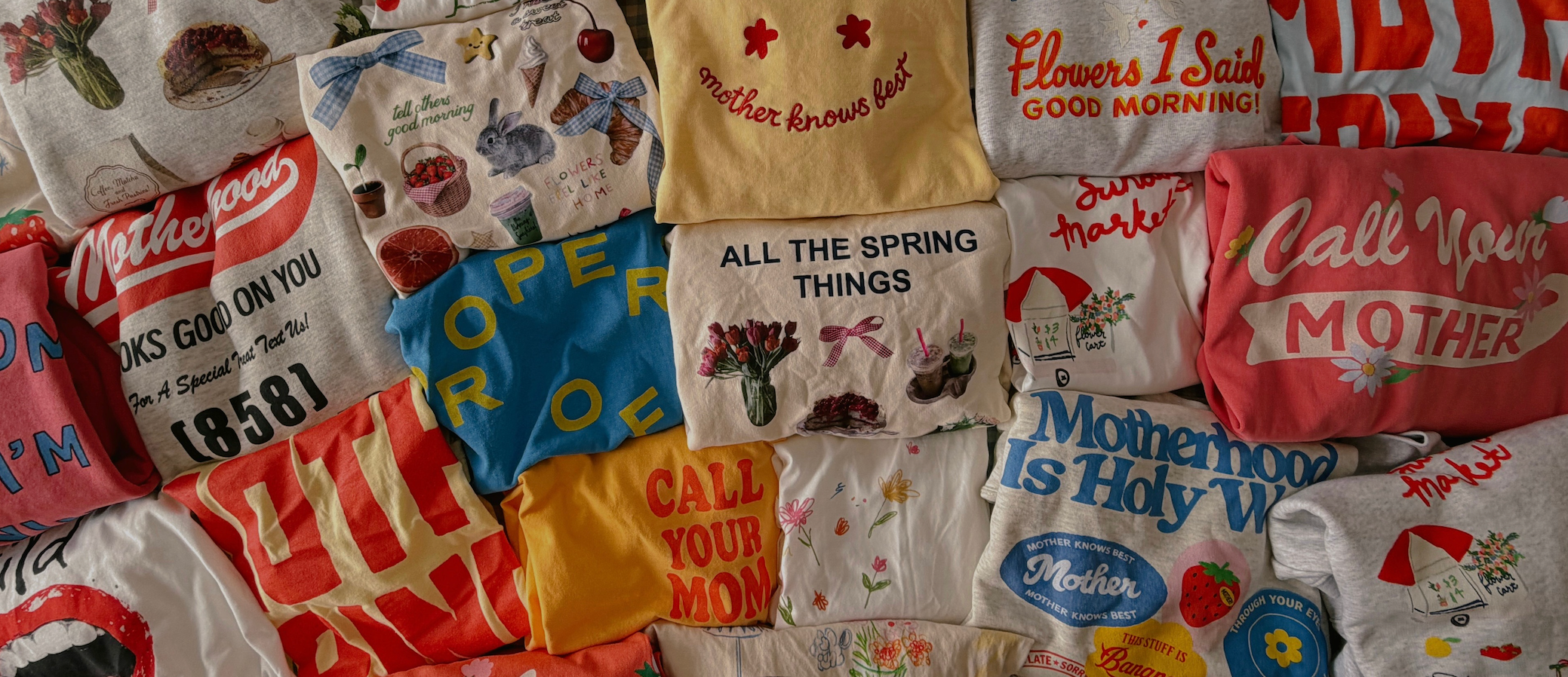 Collection of various t-shirts with different designs and text.